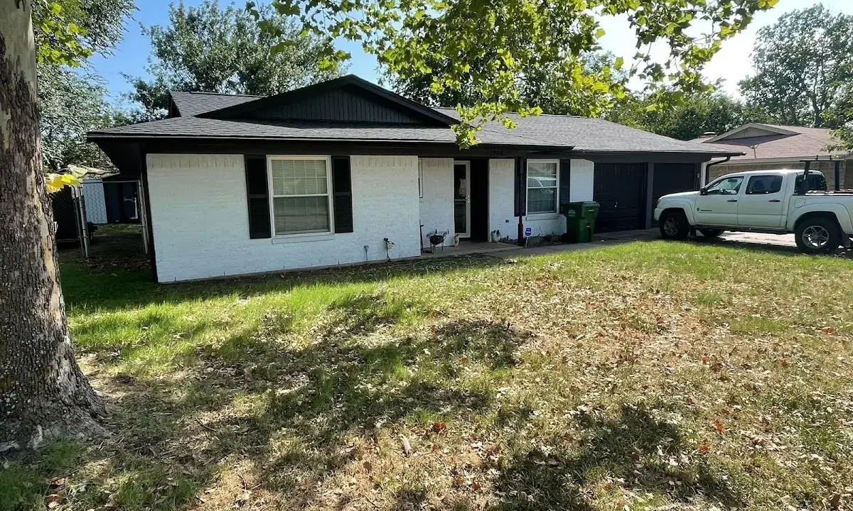 Professional roofing crew working on a residential roof in Russellville